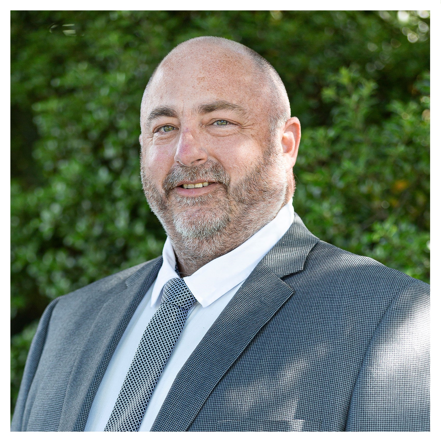 Profile picture of Council's CEO Shane Walden in a suit against a green backdrop